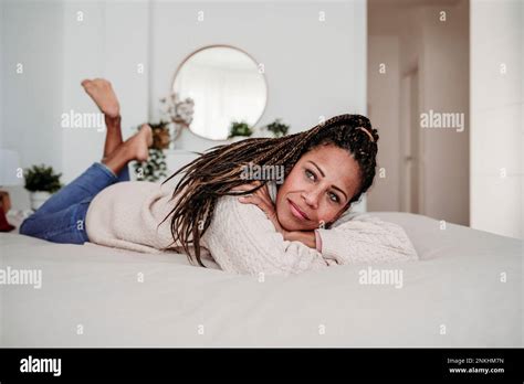 Thoughtful Mature Woman Lying On Bed At Home Hi Res Stock Photography