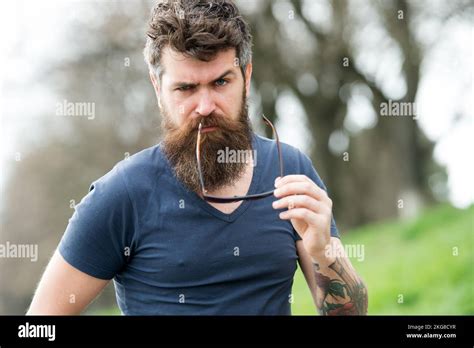 Masculinity Concept Macho With Beard And Mustache Look Confident Brutal Hold Sunglasses