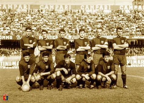 A Group Of Men Standing Next To Each Other On A Soccer Field