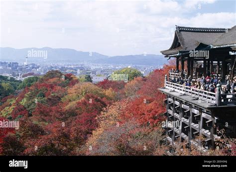 Japan, Honshu, Kyoto, Kiyomizu Temple aka Kiyomizu-dera and Autumn Leaves with Kyoto Skyline ...