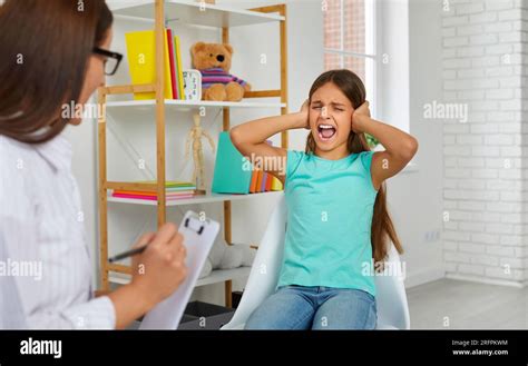 Autistic Girl Screaming And Closing Her Ears During Psychotherapy Stock