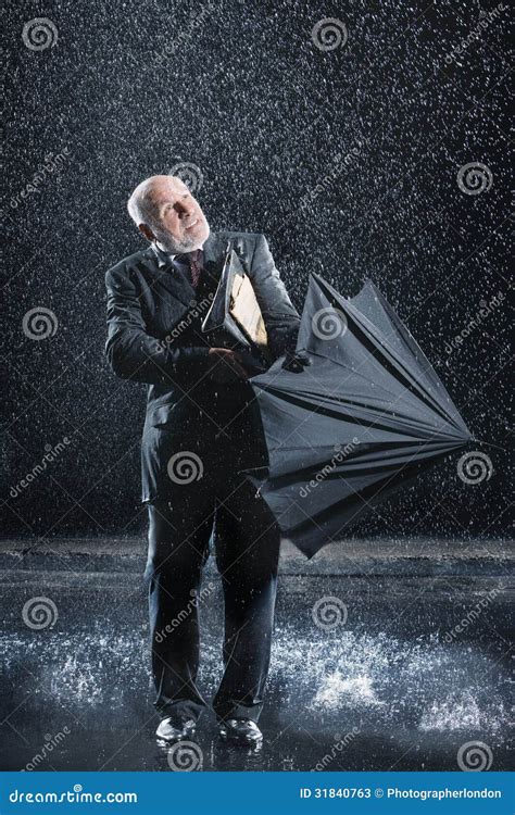 Businessman Struggling To Open Umbrella In Rain Stock Image Image Of