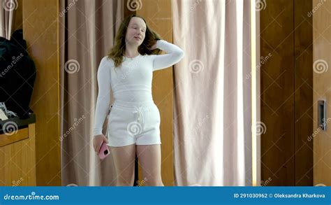 Young Girl In Fitting Rooms Puts On Sports Tight Suits Clothes New With