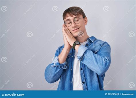 Caucasian Blond Man Standing Wearing Glasses Sleeping Tired Dreaming