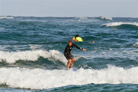 Longboard surfing at Kahana Bay - Active Oahu