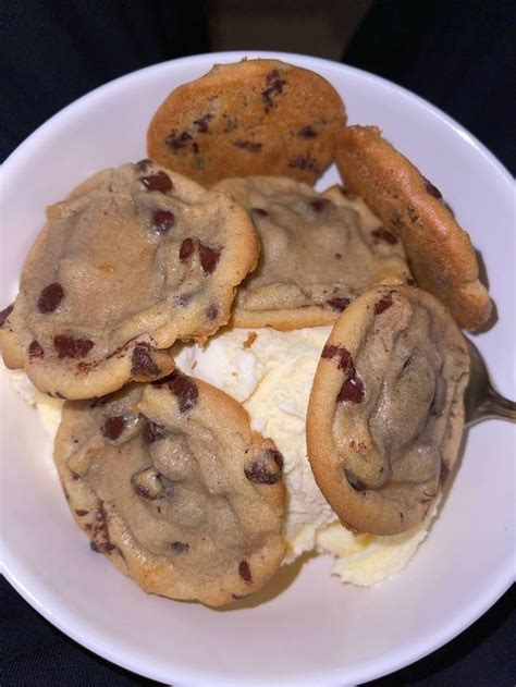 A White Plate Topped With Cookies And Ice Cream Covered In Chocolate