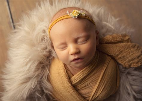 Newborn Baby Girl With Blonde Hair And Blue Eyes