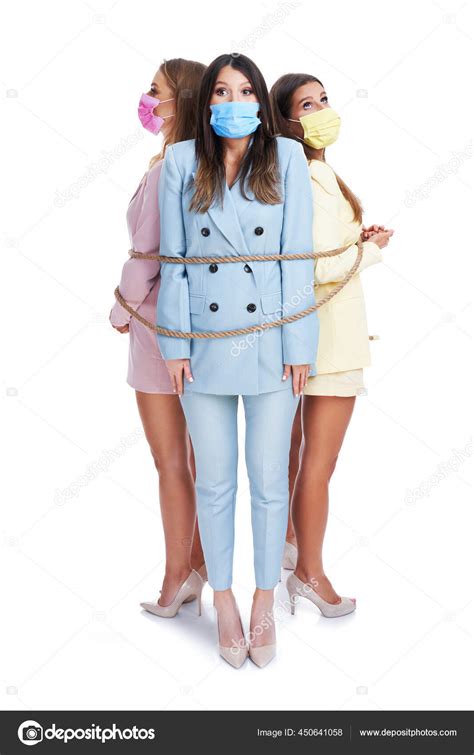 Three Women In Pastel Suits Hampered With Rope Posing Over White