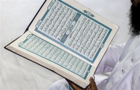 A Muslim Man Reading Holy Al Quran In His Hand Stock Photo Image Of