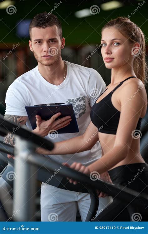 Blonde Female Working Out In Gym With Coach Stock Photo Image Of Help