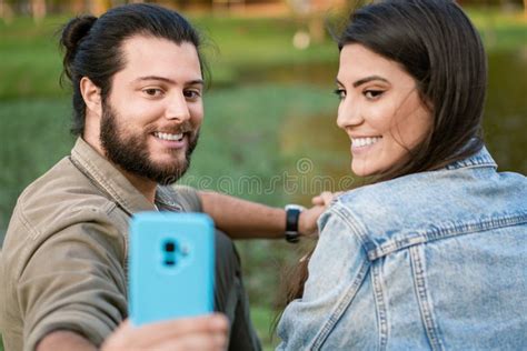 Brazilian Couple Taking Selfie With Mobile In The Park Stock Image