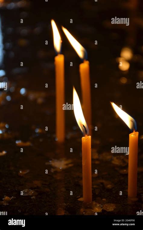 Candles burning in a church Stock Photo - Alamy