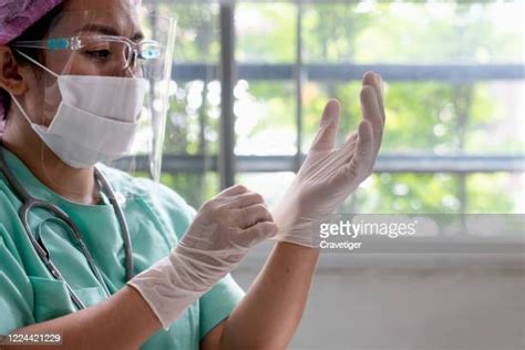 Female Doctor Putting On Gloves Photos And Premium High Res Pictures