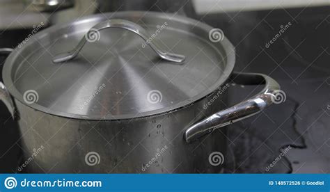 Boiling Water in the Pan that is Covered with a Lid in the Kitchen ...