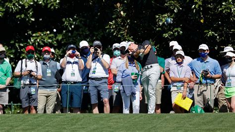 Patrons Watch Rory Mcilroy Of Northern Ireland Play A Stroke From The