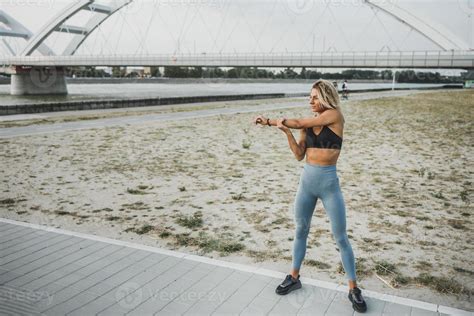 Fit Woman Stretching Her Arm While Working Up Outdoors Training