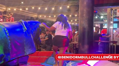 Brunette Girl In Black And White Clothes Riding On A Mechanical Bull In Benidorm K YouTube