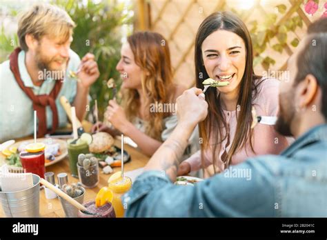 Happy Friends Lunching With Healthy Food In Bar Restaurant Young