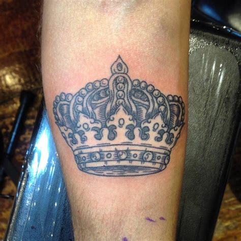 Engraving style crown tattoo located on the inner