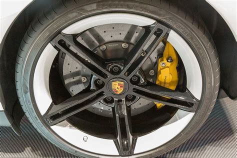 Close-up of Porsche tyres on electric sports car Taycan Turbo S ...