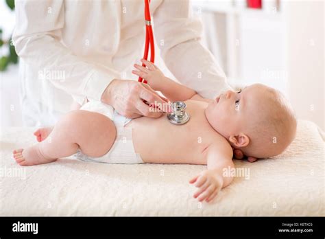 Pediatrician Examines Baby Using Stethoscope To Listen To Baby S Chest