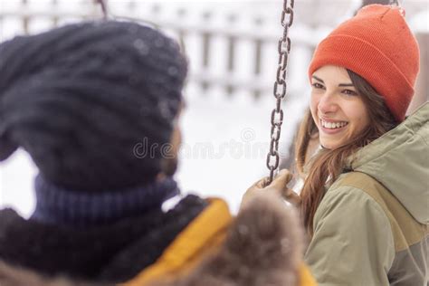 Couple Relaxing Outdoors While On Winter Vacation Stock Image Image