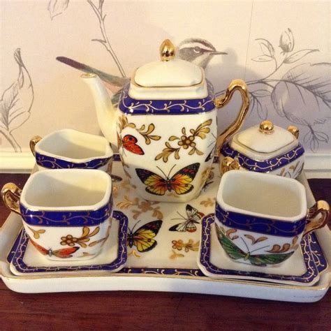 A Porcelain Tea Set With Butterflies On It