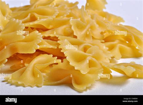 A Closeup Image Of Uncooked Bow Tie Pasta On A Plain Background Stock