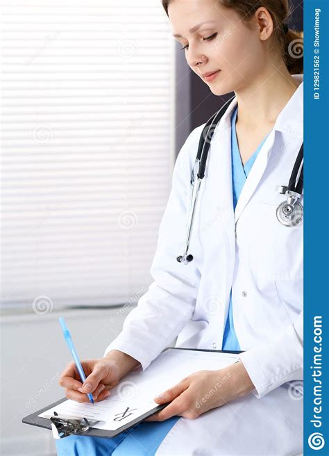 Woman Doctor At Work At Hospital Young Female Physician Write