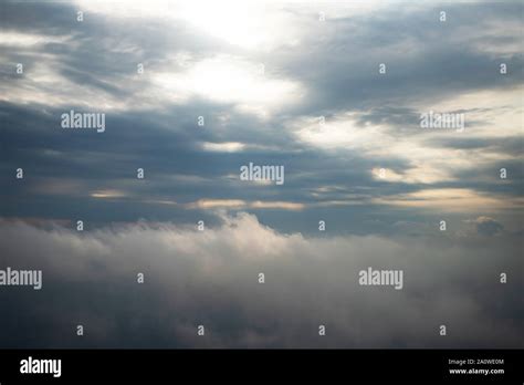 Looking Down Through Dramatic Clouds To Planet Earth Stock Photo Alamy