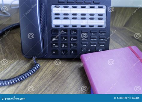 Office Telephone Console On Wood Table With Notebooks Stock Image