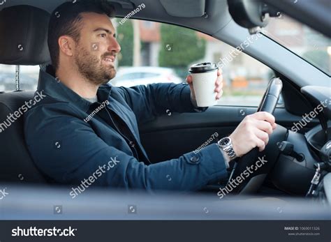 Portrait Man Drinking Coffee While Driving Stock Photo 1069011326