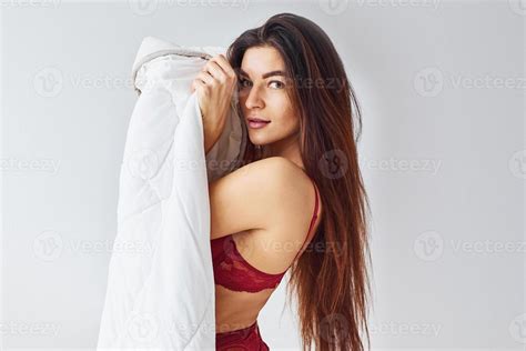 Woman In Red Underwear Covering Her Body By Towel In The Studio Against