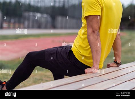 Strong Man In Comfortable Clothes Doing Backward Push Ups Leaning On