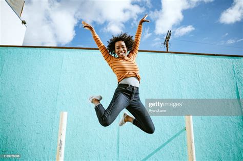 Celebrating Woman Jumps Into The Air High Res Stock Photo Getty Images