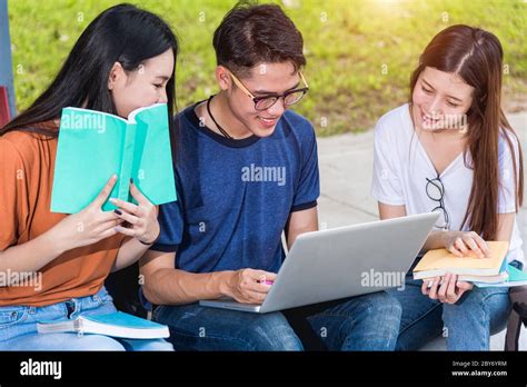 Happy Group Students Studying Outdoors Consult Together With Laptop