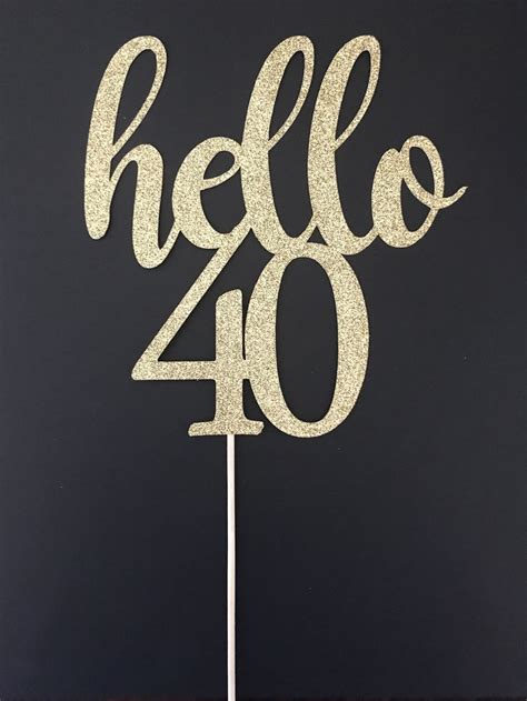 A Cake Topper With The Word Hello 40 Written In Gold Glitter On A Black