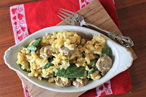 A White Bowl Filled With Pasta And Meat On Top Of A Red Napkin Next To