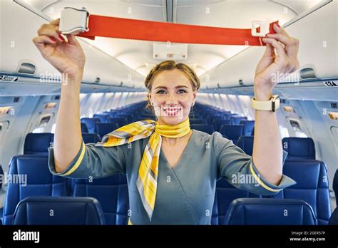 Air Hostess Performing A Pre Flight Safety Demonstration Before The