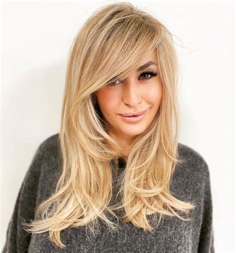 Bangs To The Side And Face Framing Layers Medium Length Hair With