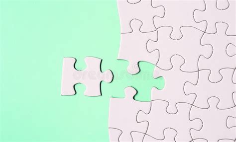 White Jigsaw Puzzle With Some Missing Pieces On Green Background Flat Lay Stock Image Image