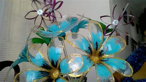 Three Blue Flowers Are In A Clear Vase