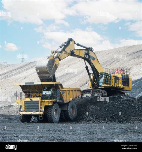 Big Yellow Mining Truck And Excavator Working In Quarry Loading Coal