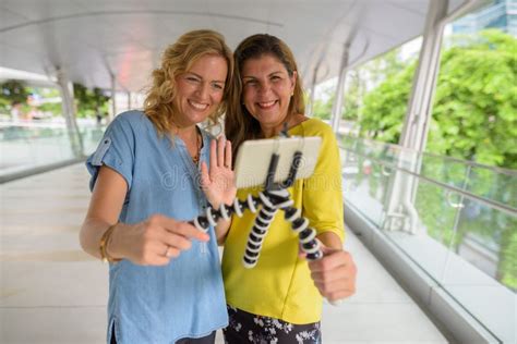 Portrait Of Two Woman Vlogging And Taking Selfie With Mobile Phone