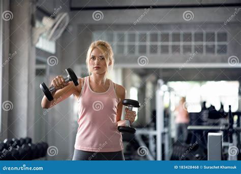 Strong Woman Doing Exercises With Dumbbells In Gym Stock Photo Image