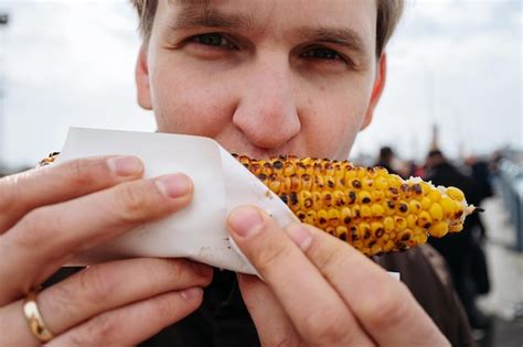 Premium Photo Close Up Of Hand Holding Corn