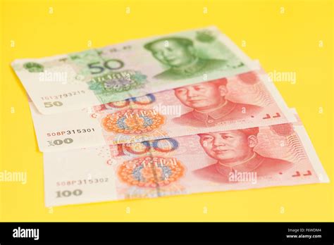 Chinese Yuan Banknotes On Yellow Background Stock Photo Alamy