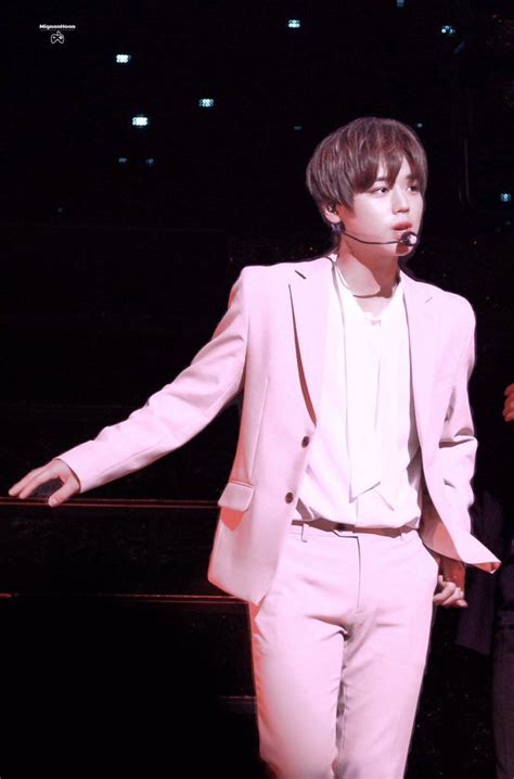 A Male In A Pink Suit And White Shirt Is Holding His Hands Out To The Side