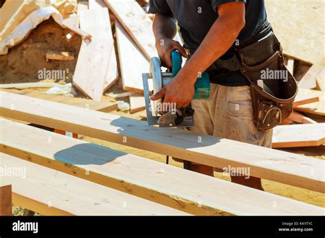 Carpenter Using Circular Saw For Cutting Wooden Boards Construction