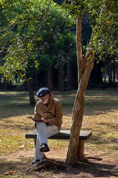 Premium Photo Old Man Sitting On The Bench Reading A Book Man